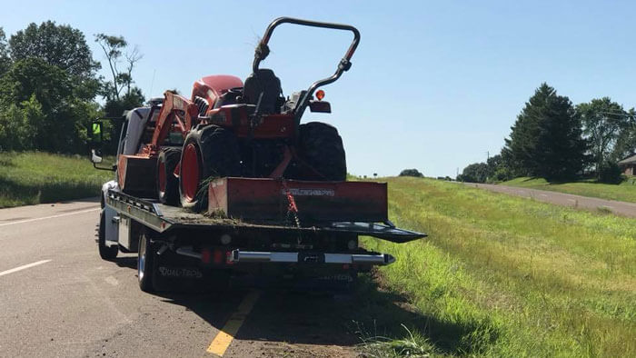 towing farm equipment that turned over